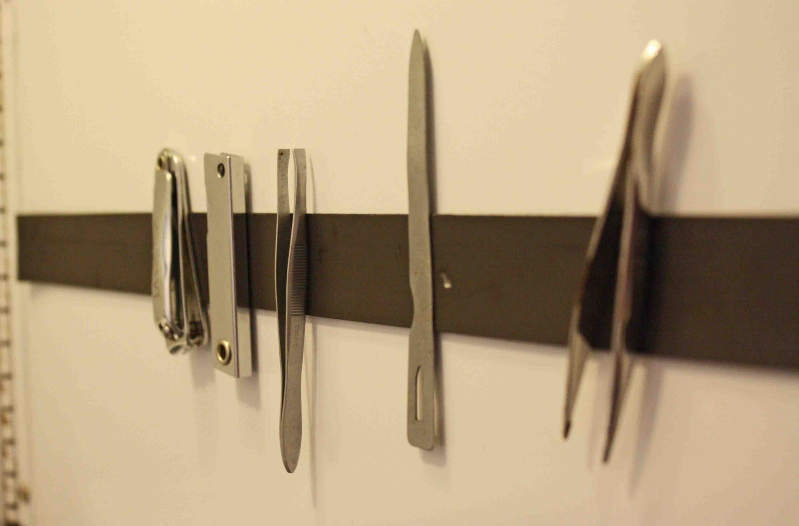 Add a magnetic strip to the inside of a medicine cabinet to organize nail clippers, bobby pins, tweezers, etc.