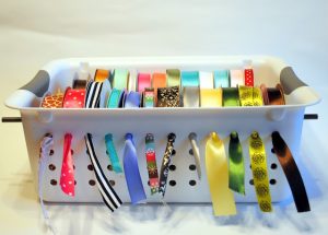 Create a fun ribbon organizer by using the simple bin and a rod
