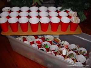 Keep Christmas decorations safe and organized by using cardboard and red plastic cups