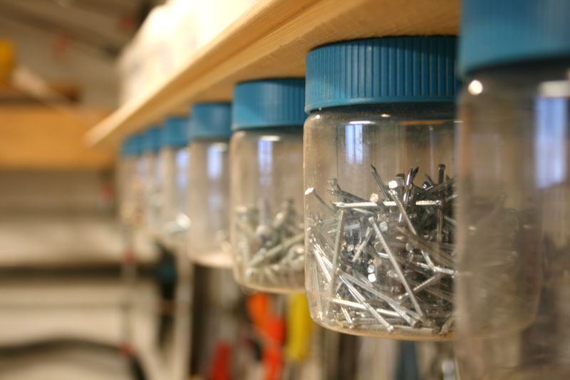 Mount empty jars underneath shelving to keep nails and screws organized