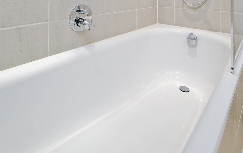 Scrub bathtub with a baking soda paste and a scrub brush