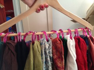 Use shower curtain hooks and a clothes hanger to hang and organize your ties and scarves in the closet