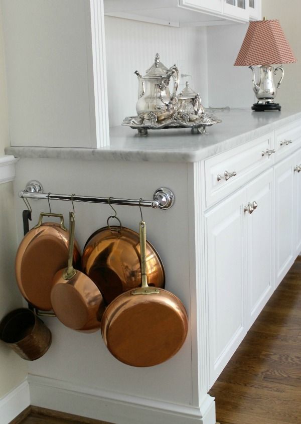 Attach a short rail to the side of your cabinet to magically turn the empty space into storage