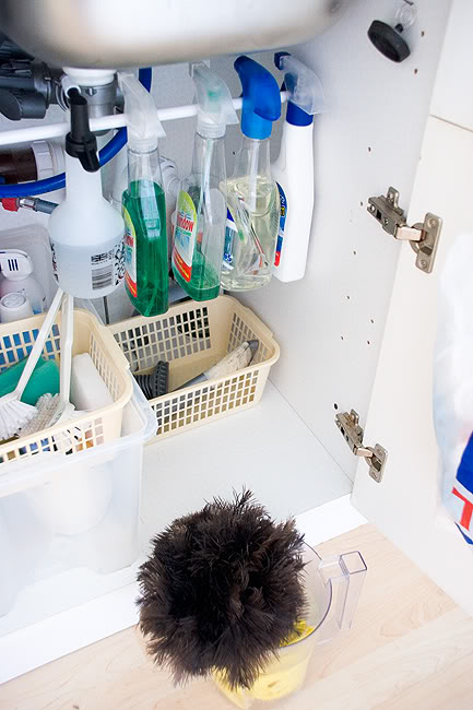 Organize cleaning bottles under the sink with a tension rod