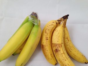 Secure plastic wrap around a bunch of bananas to slow the ripening process