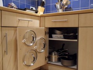 Store your pot lids on the back of the cabinet with adhesive hooks