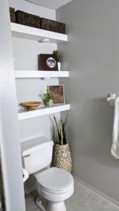 Install floating shelves to use the space above the toilet