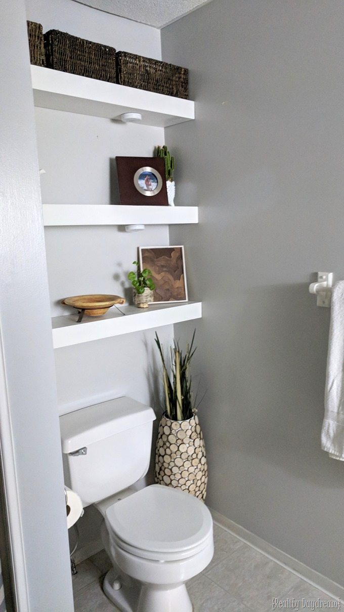 Install floating shelves to use the space above the toilet